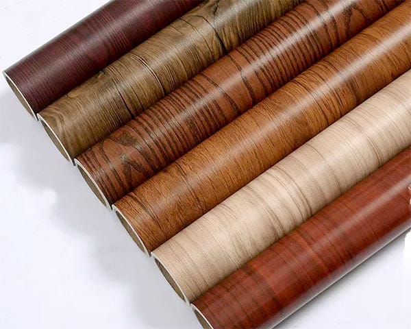 Laminated color PVC window profile with woodgrain film finish showing the surface quality and color consistency achievable through film lamination on white PVC substrate for residential and commercial window applications