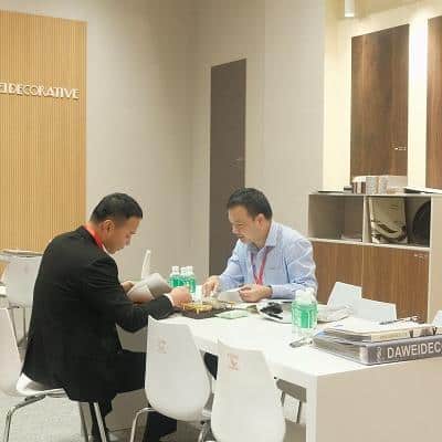 The 55th Guangzhou Furniture Fair Moments of Business Communication Beside the Melamine Display Area